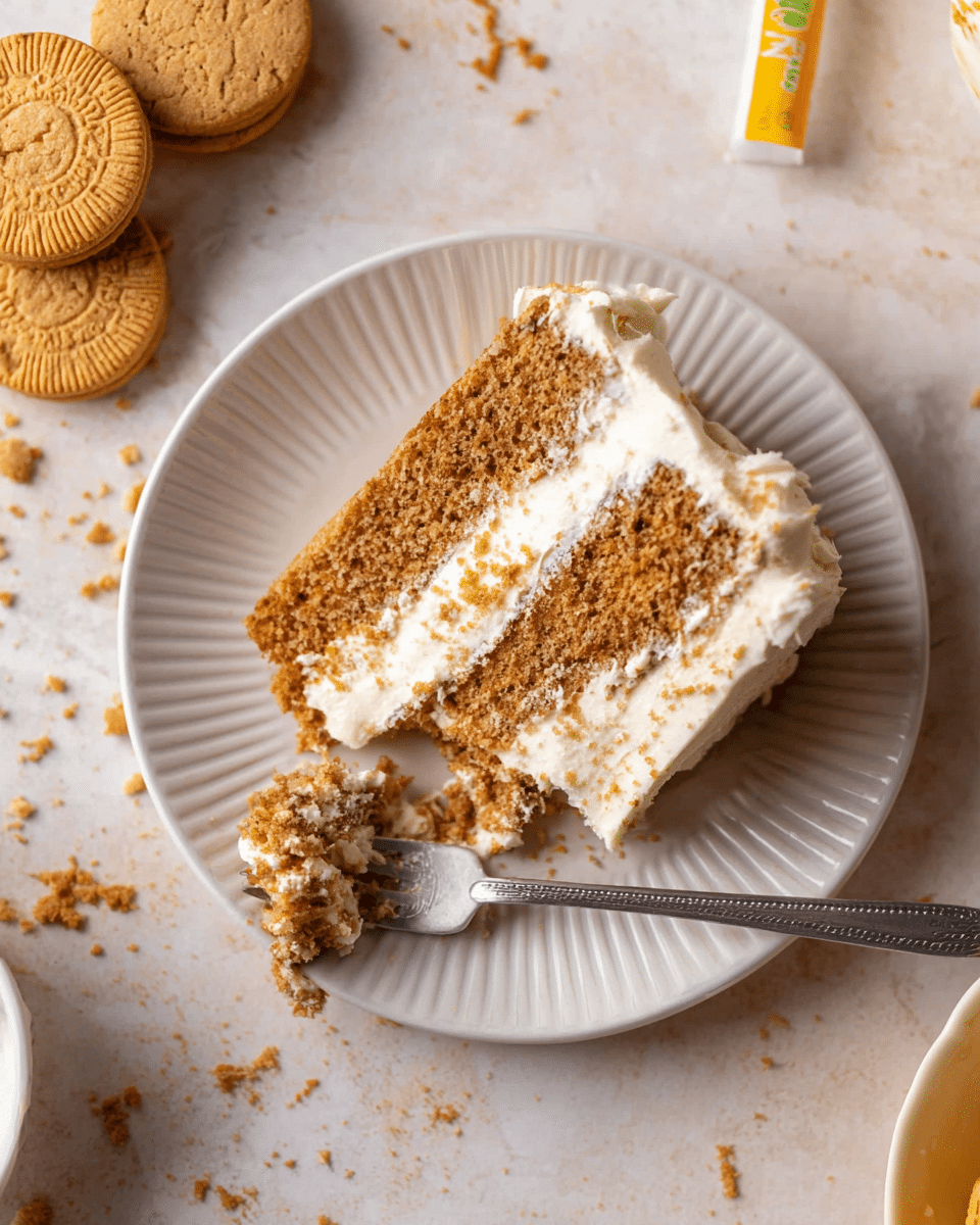 A slice of three-layer light brown cake with white frosting between each layer and on the outside, placed on a white plate with a ridged edge. A fork with a piece of cake on it rests beside the slice on the plate. In the top left corner, there are two round sandwich cookies with a cream filling and crumbs scattered around, all on a white marbled surface. photo taken with an iphone --ar 4:5 --v 7