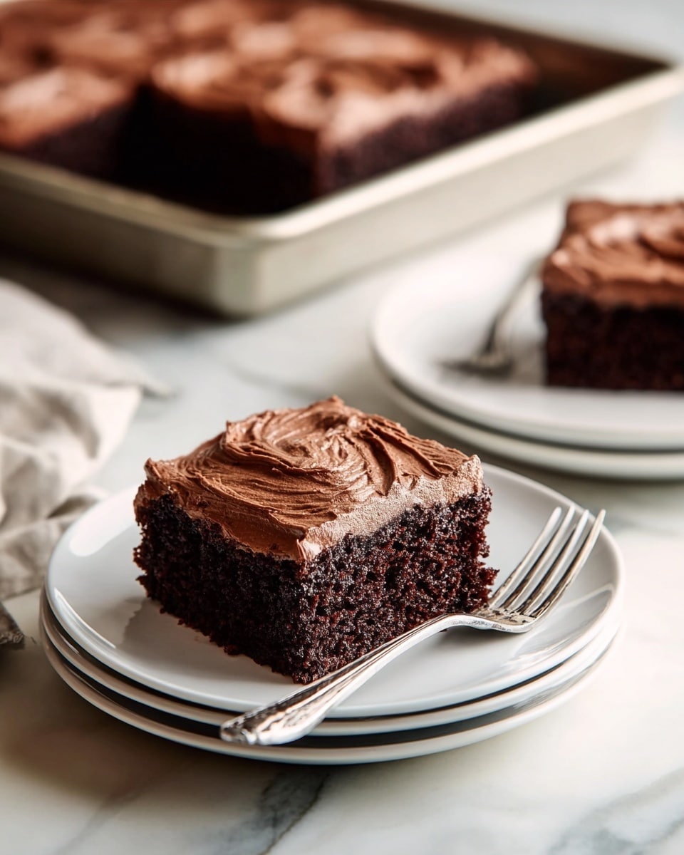 A piece of chocolate cake with two thick dark brown layers sits on a white plate on a white marbled surface. Each cake layer looks moist and soft with a deep chocolate color. The top layer is covered with thick, swirled milk chocolate frosting that looks creamy and smooth with visible texture from spreading. A fork lies on the plate near the cake with some crumbs and chocolate frosting, showing a small bite taken from the cake. Photo taken with an iphone --ar 4:5 --v 7