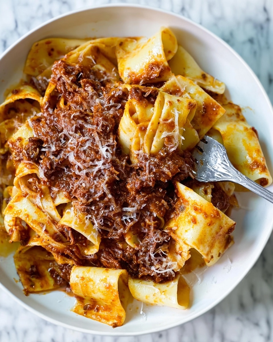 The image shows a white plate filled with wide, flat pasta ribbons layered and mixed with a thick, rich brown meat sauce. The pasta is creamy yellow and looks soft with some folds and curls, coated heavily with the dark, chunky sauce that has bits of meat and a slightly oily shine. Some grated cheese is lightly sprinkled on top, adding fine white strands over the sauce. A silver fork is digging into the pasta on the right side of the plate, with the pasta wrapped around its tines. The background is a white marbled texture. photo taken with an iphone --ar 4:5 --v 7