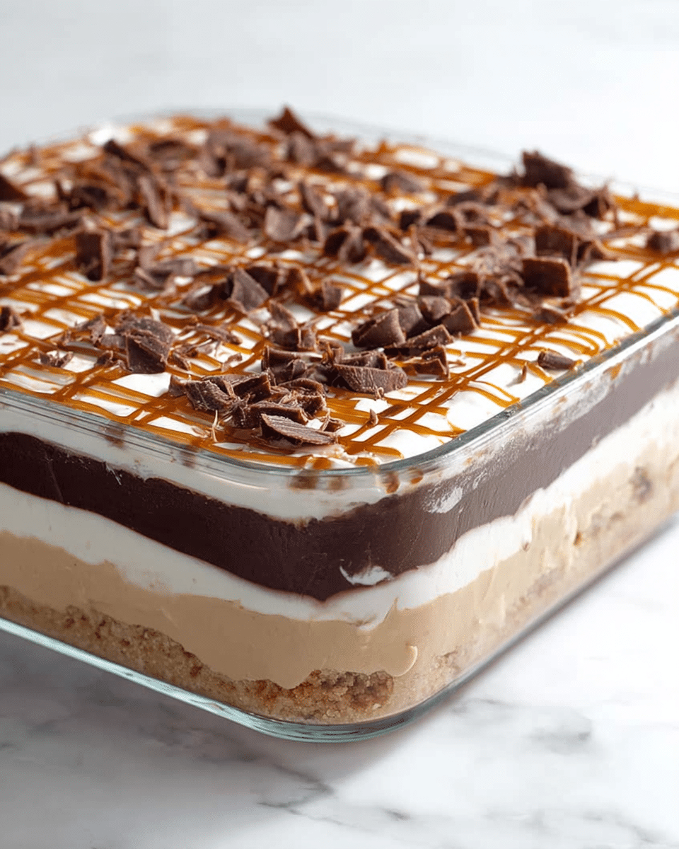 The image shows a dessert in a clear glass rectangular dish with four distinct layers. At the bottom, there is a light brown crumbly crust layer. Above that is a thick, creamy beige layer. Next is a thick, dark chocolate layer, smooth and glossy, followed by a thick white creamy layer on top. The top layer is decorated with a light brown caramel drizzle forming a grid pattern and scattered chocolate shavings that are curly and textured. The dish is placed on a white marbled surface. photo taken with an iphone --ar 4:5 --v 7