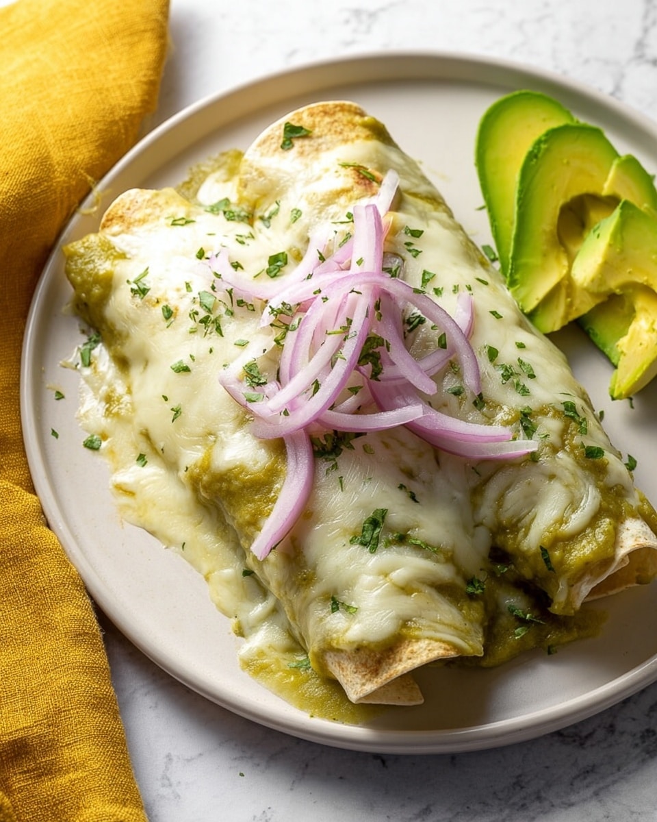 A plate holds two rolled enchiladas covered with a creamy green sauce that appears smooth and slightly thick. On top, a melted white cheese layer spreads over the enchiladas, sprinkled with small green herb pieces. Thin pale purple onion rings are placed over the cheese, adding a fresh and crisp look. At the back right of the plate, there are three bright green avocado slices neatly arranged. The plate is white and sits on a white marbled surface, with a yellow cloth beside it. photo taken with an iphone --ar 4:5 --v 7