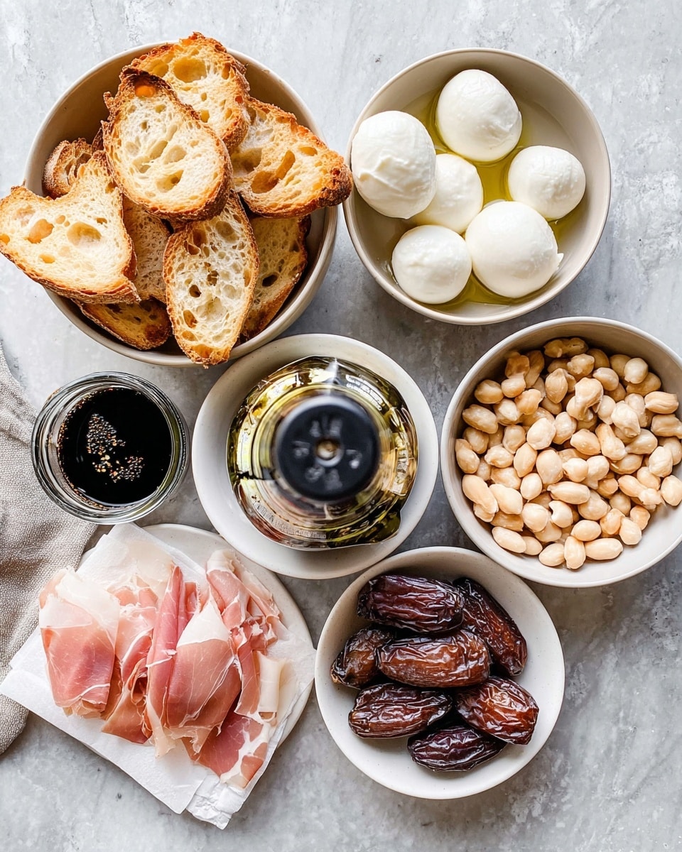 The image shows a top view of several white bowls set on a white marbled surface, each filled with different ingredients. One bowl holds toasted bread slices in light golden brown with holes and crispy edges, piled high. Another bowl contains smooth, white, creamy mozzarella balls, looking soft and fresh. A third bowl is filled with small, round, pale beige nuts, closely packed. Next to this, a bowl of dark brown dates with wrinkled skin is arranged neatly. In the middle, a small white plate has two thin slices of pinkish, marbled prosciutto on a piece of white paper. A bottle of balsamic glaze is placed upright near the mozzarella bowl, with a dark syrupy liquid visible inside. The setup feels organized and ready for assembling a snack or appetizer. Photo taken with an iphone --ar 4:5 --v 7