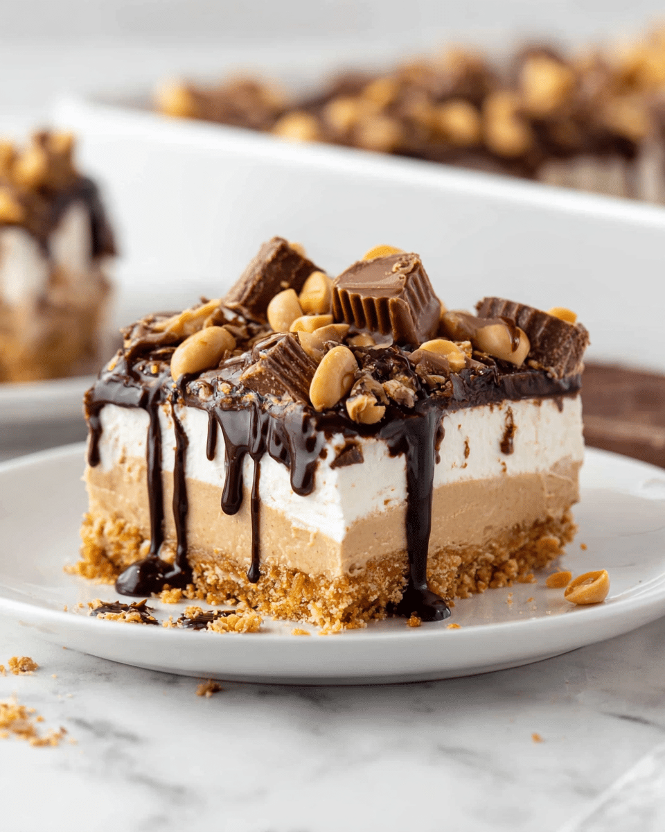 A close-up of a square slice of layered dessert on a white plate, set on a white marbled surface. The bottom layer is a crumbly golden brown crust. Above this is a thick, smooth beige layer. Next is a dark chocolate layer topped with a white creamy layer that drips slightly down the sides. The top is covered with chunks of peanut butter cups, peanut pieces, and drizzles of dark chocolate sauce. In the background, more dessert can be seen in a white rectangular dish. photo taken with an iphone --ar 4:5 --v 7