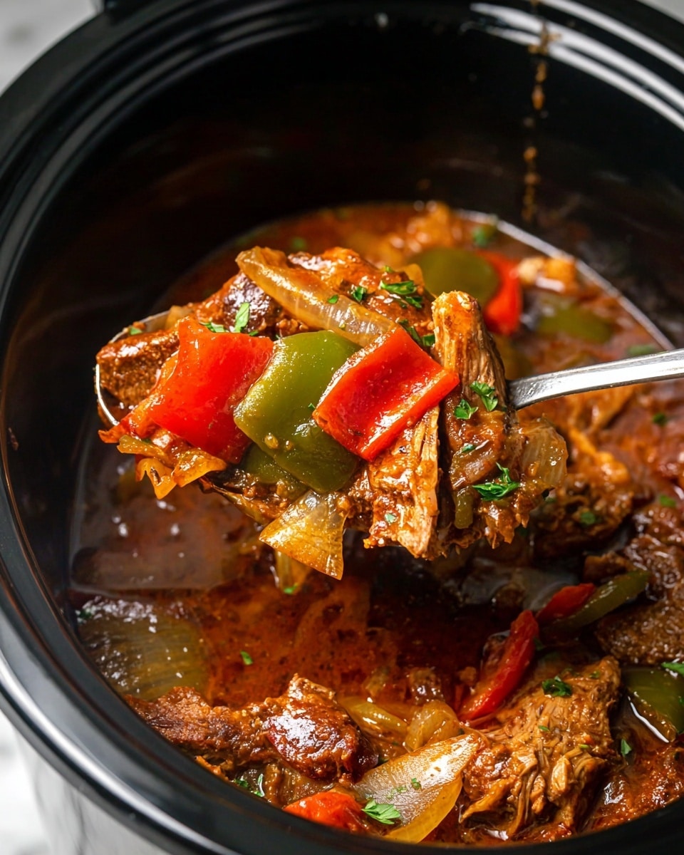 The image shows a close-up of a cooked dish inside a slow cooker with a silver spoon lifting a portion. The dish has a rich, brownish-red sauce as the base layer with visible chunks of cooked meat layered throughout. On top of the meat, there are slices of green and red bell peppers and translucent cooked onions, all mixed with small bits of herbs sprinkled around. The texture looks moist and tender with a glossy sauce coating all ingredients. The slow cooker rests on a white marbled surface. Photo taken with an iphone --ar 4:5 --v 7