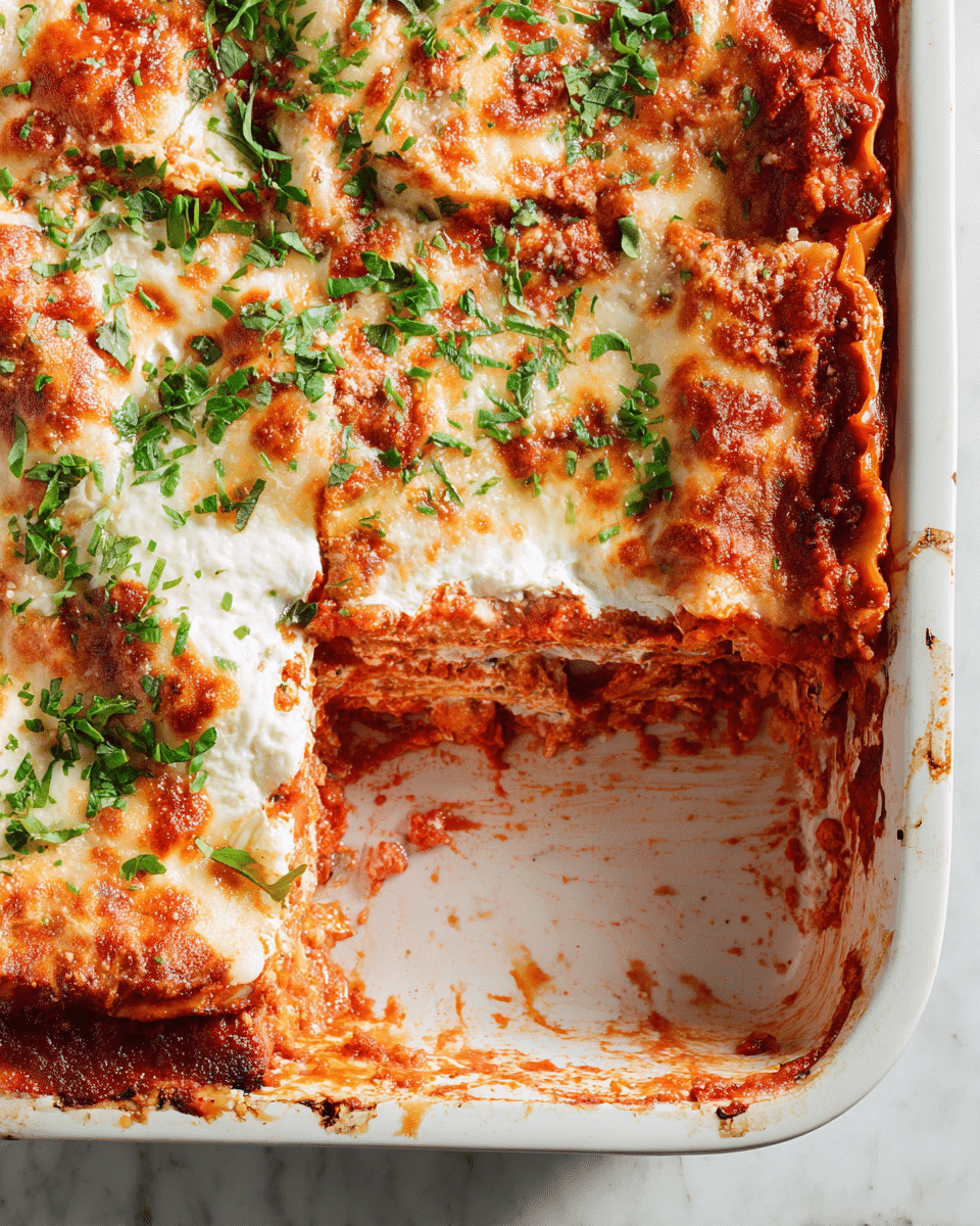 A close-up view of a baked lasagna inside a white baking dish shows four visible layers: the bottom layer is dark red tomato sauce, the second and fourth layers are creamy white ricotta cheese, the third layer is a mix of melted mozzarella cheese with orange-browned spots, and fresh green chopped herbs sprinkled on top add contrast. One corner of the lasagna is missing, revealing the thick, gooey texture of the cheese and sauce mixture inside. The baking dish is placed on a white marbled surface with some sauce splatters around the edges. photo taken with an iphone --ar 4:5 --v 7